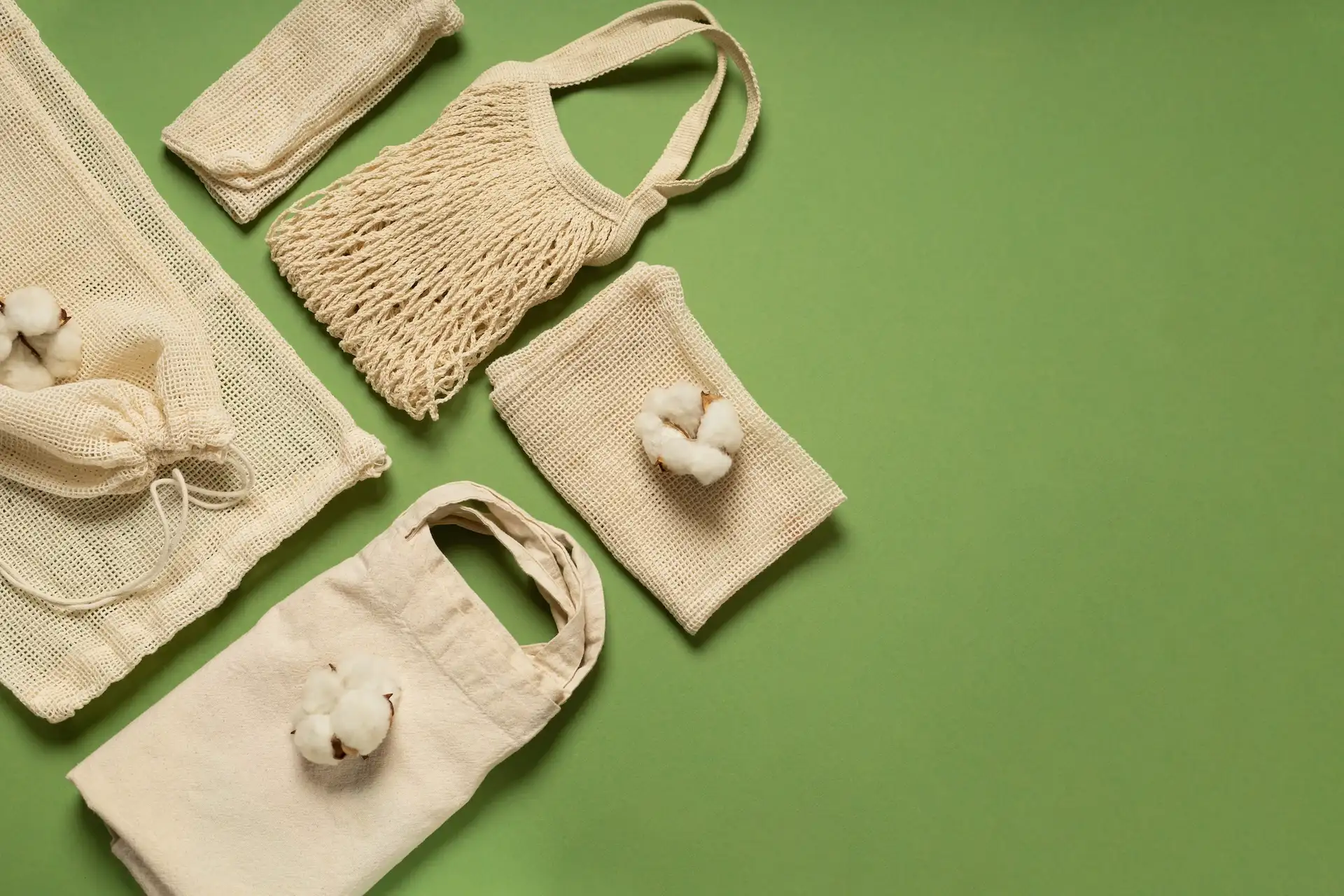 Natural jute bags on a green background